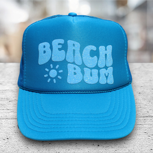 neon blue trucker hat with glitter vinyl saying beach bum