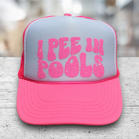 neon pink/white trucker hat with glitter vinyl saying I pee in pools