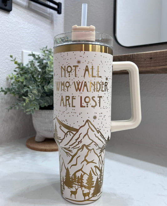 Not All Who Wander design on cream/gold tumbler